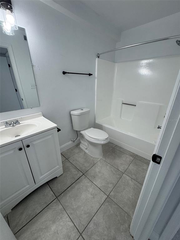 1195 Bentley Road, Unit 1 Leesburg, FL 34748 - Photo 10 of 13 a bathroom with a toilet sink and mirror