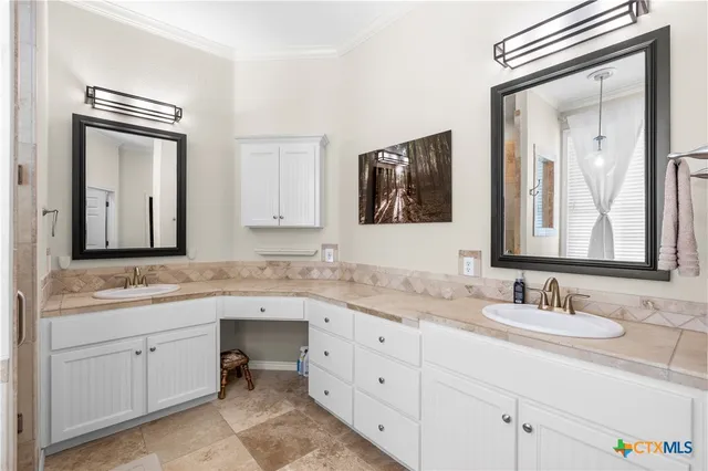 a bathroom with a granite countertop sink mirror and