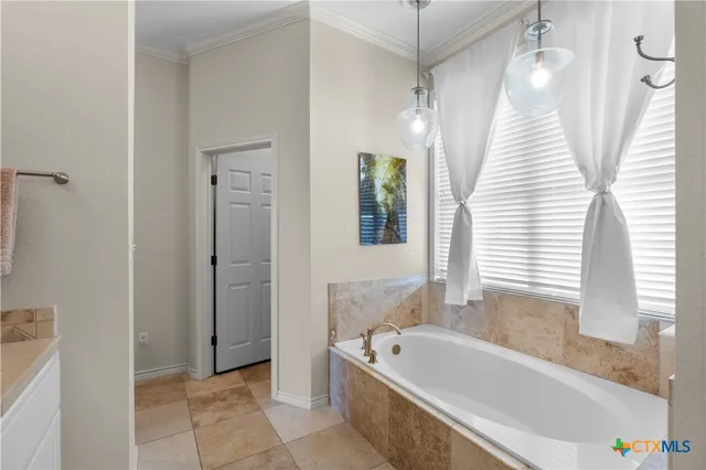 a bathroom with a bathtub a shower and a sink