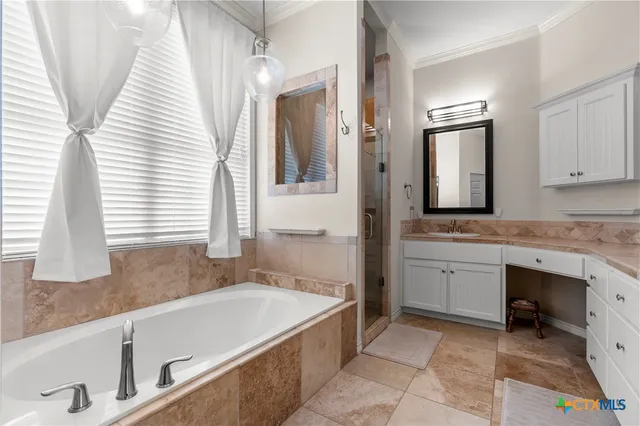 a bathroom with a granite countertop sink and a bathtub