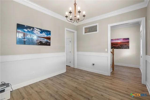 a view of a room with wooden floor and windows