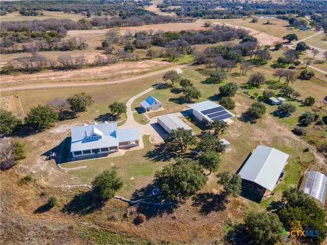 an aerial view of a house with a lake view
