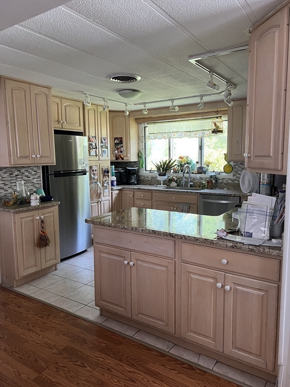 53 Wagon Hill Road Marlborough, MA 01752 - Photo 12 of 32 a kitchen with kitchen island granite countertop a sink cabinets and stainless steel appliances