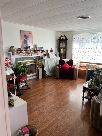 a living room with furniture fireplace and window