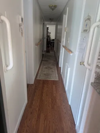 a view of a hallway view with wooden floor and staircase