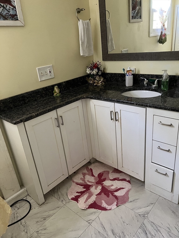 53 Wagon Hill Road Marlborough, MA 01752 - Photo 16 of 32 a bathroom with a sink and a mirror