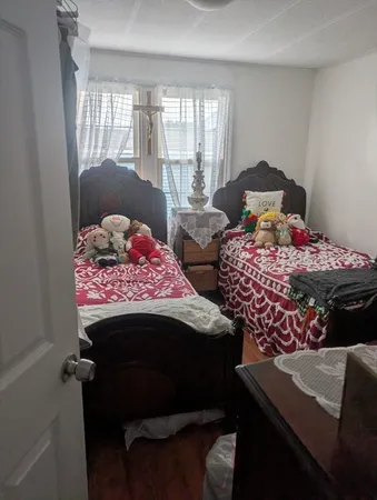 a bedroom with two beds and a window