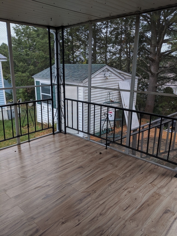 53 Wagon Hill Road Marlborough, MA 01752 - Photo 27 of 32 a view of a balcony with wooden floor and iron fence