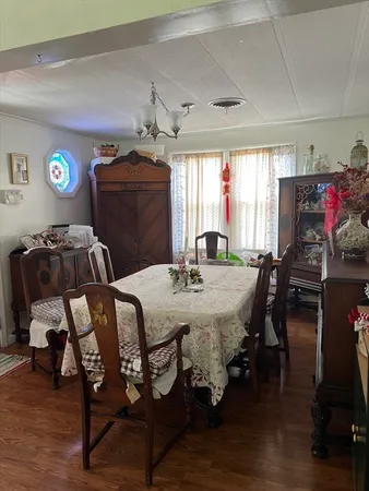 a view of a dining room with furniture and window