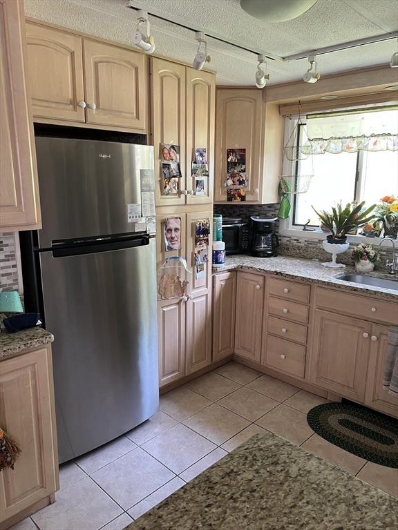 53 Wagon Hill Road Marlborough, MA 01752 - Photo 10 of 32 a kitchen with stainless steel appliances a refrigerator sink and cabinets