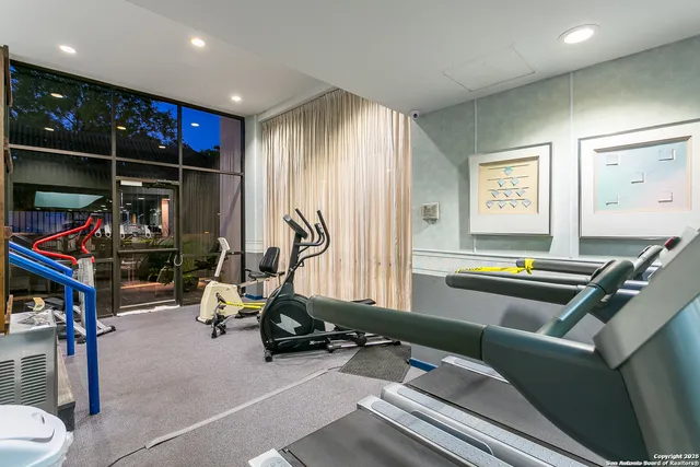 a room with gym equipment and a flat screen tv