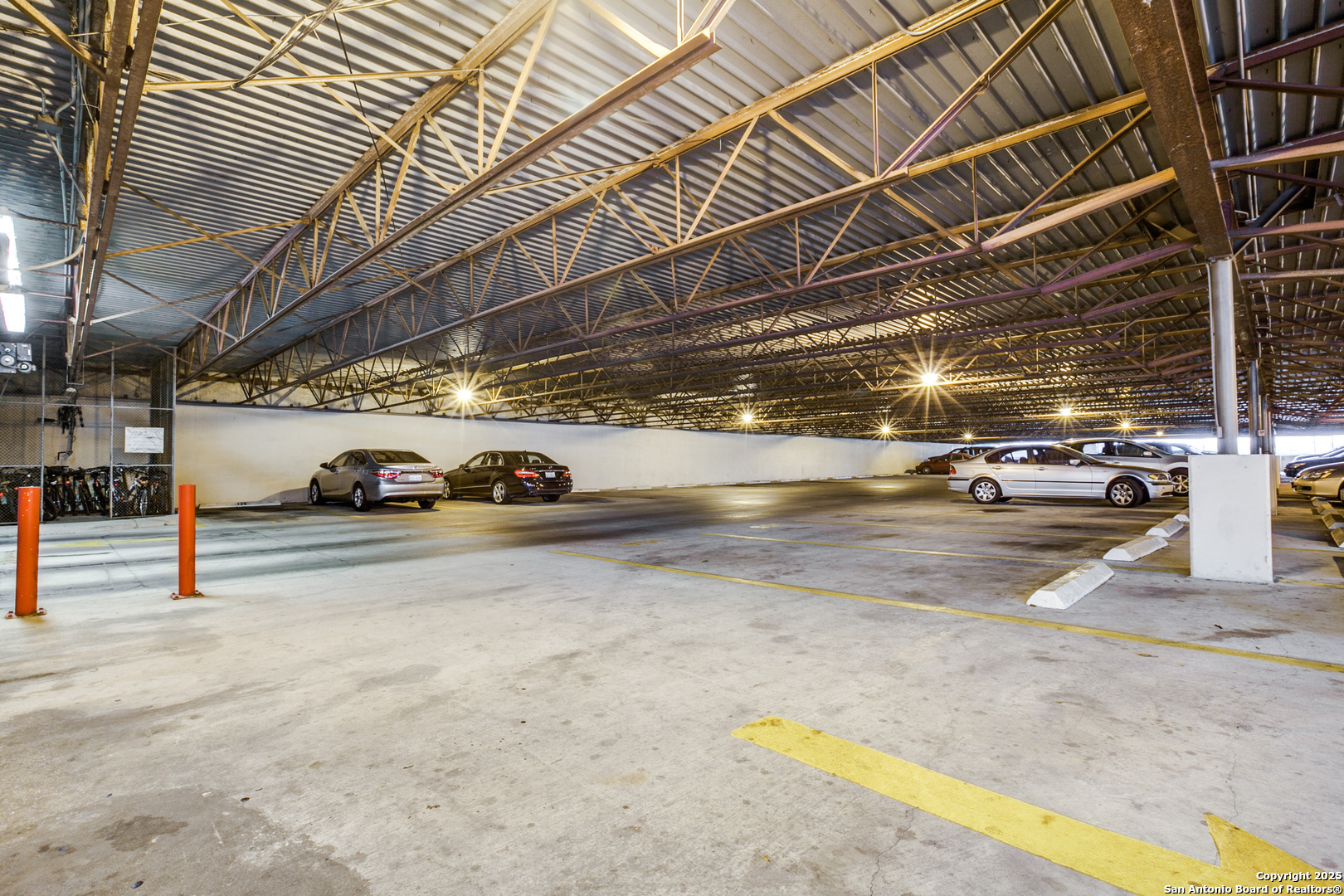 7701 Wurzbach Road, Unit 301 San Antonio, TX 78229 - Photo 18 of 42 a view of parking garage with cars