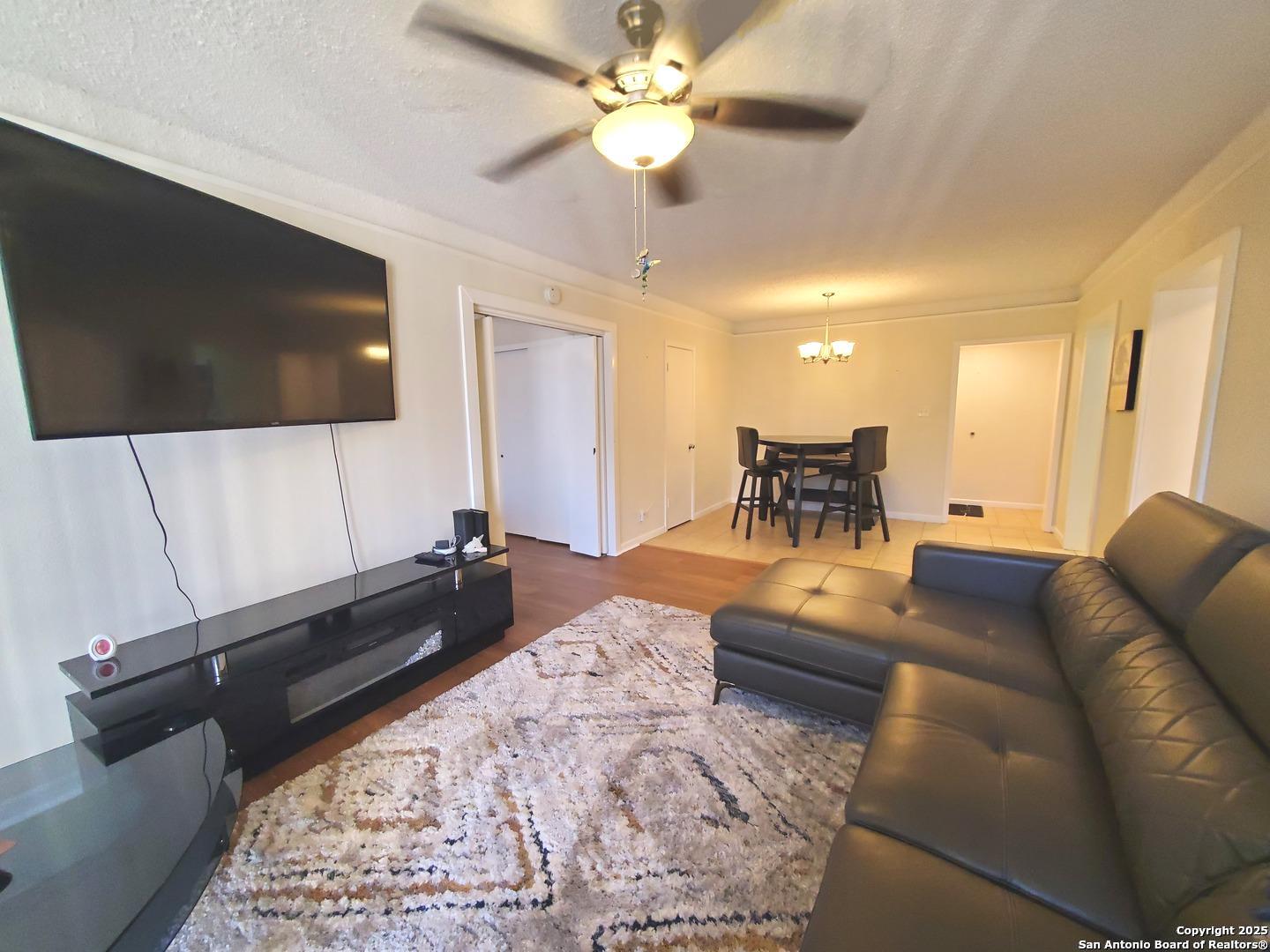 7701 Wurzbach Road, Unit 301 San Antonio, TX 78229 - Photo 19 of 42 a living room with furniture and a flat screen tv