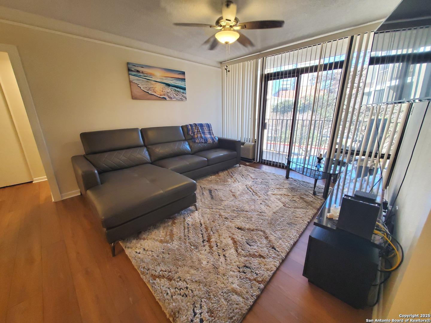 7701 Wurzbach Road, Unit 301 San Antonio, TX 78229 - Photo 20 of 42 a living room with furniture and a flat screen tv