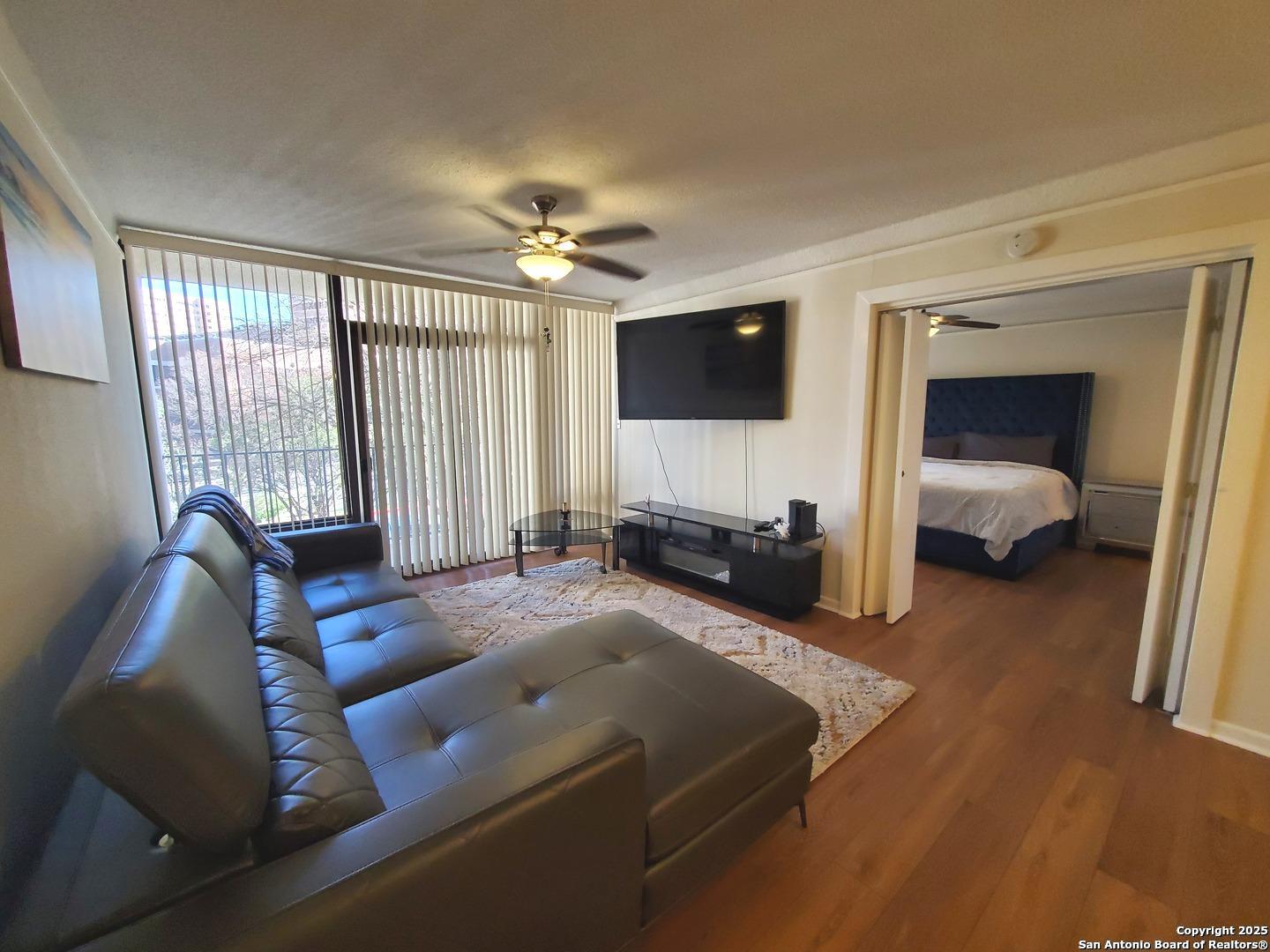 7701 Wurzbach Road, Unit 301 San Antonio, TX 78229 - Photo 21 of 42 a living room with furniture and a flat screen tv