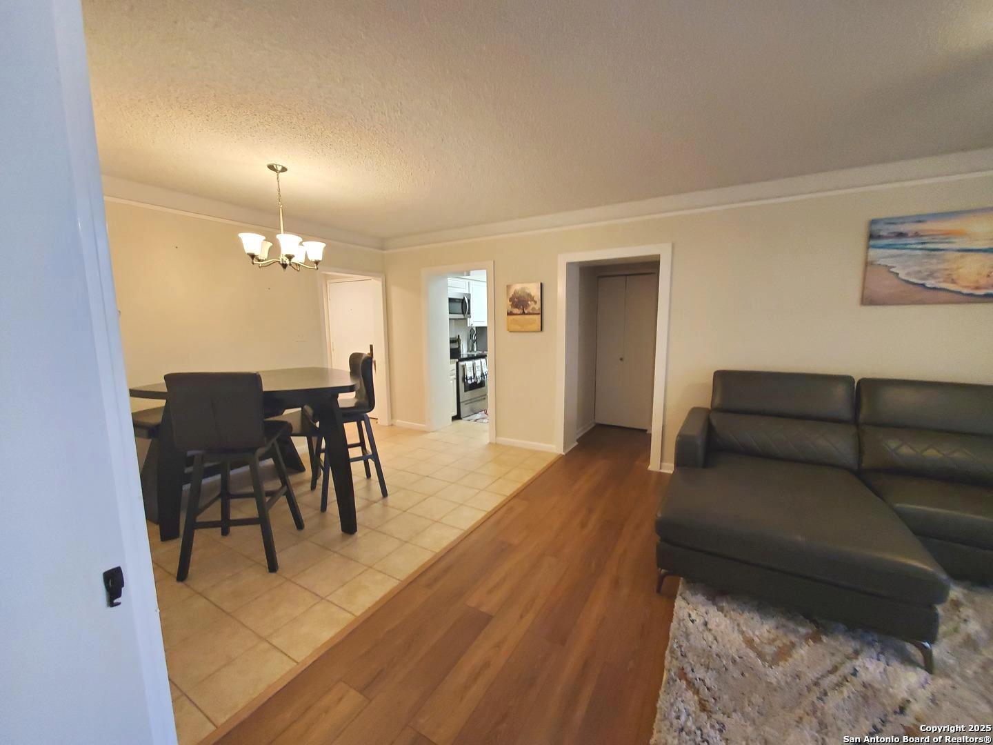 7701 Wurzbach Road, Unit 301 San Antonio, TX 78229 - Photo 22 of 42 a living room with furniture and a dining table