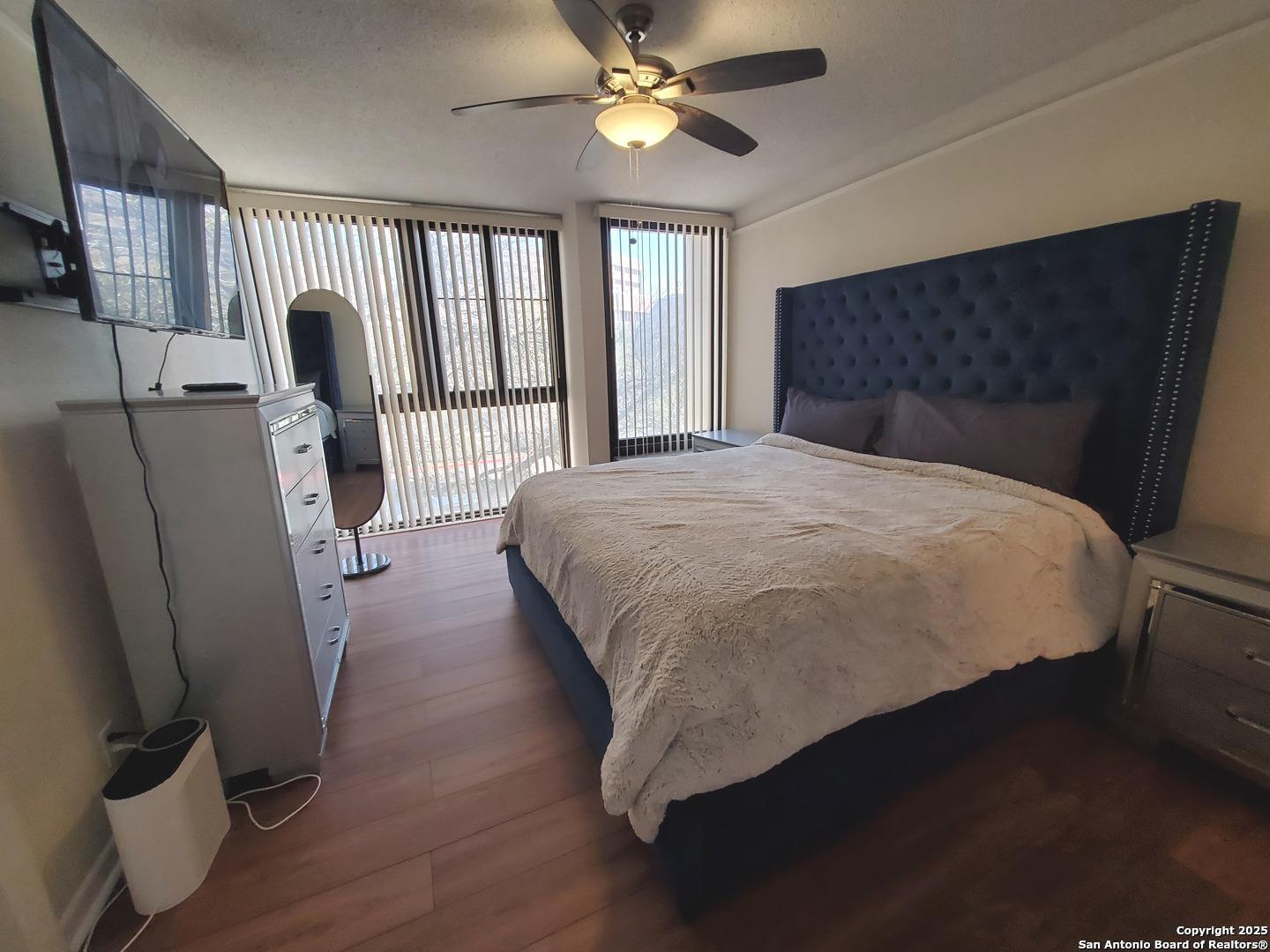 7701 Wurzbach Road, Unit 301 San Antonio, TX 78229 - Photo 31 of 42 a bedroom with a bed and a large window