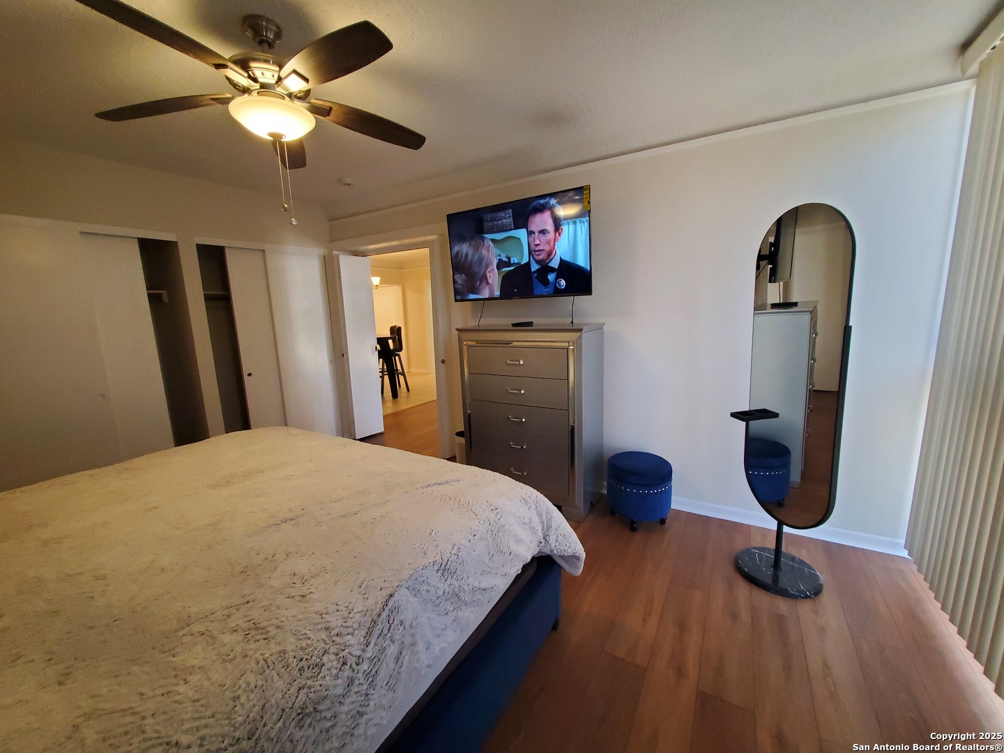 7701 Wurzbach Road, Unit 301 San Antonio, TX 78229 - Photo 33 of 42 a bedroom with a bed and a chandelier