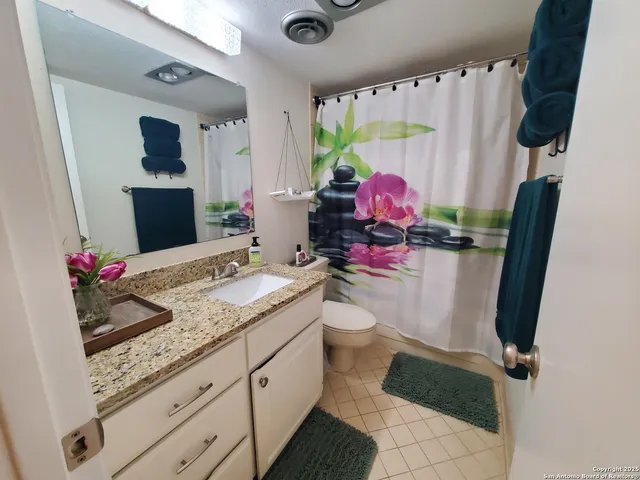 a bathroom with a sink toilet and a mirror