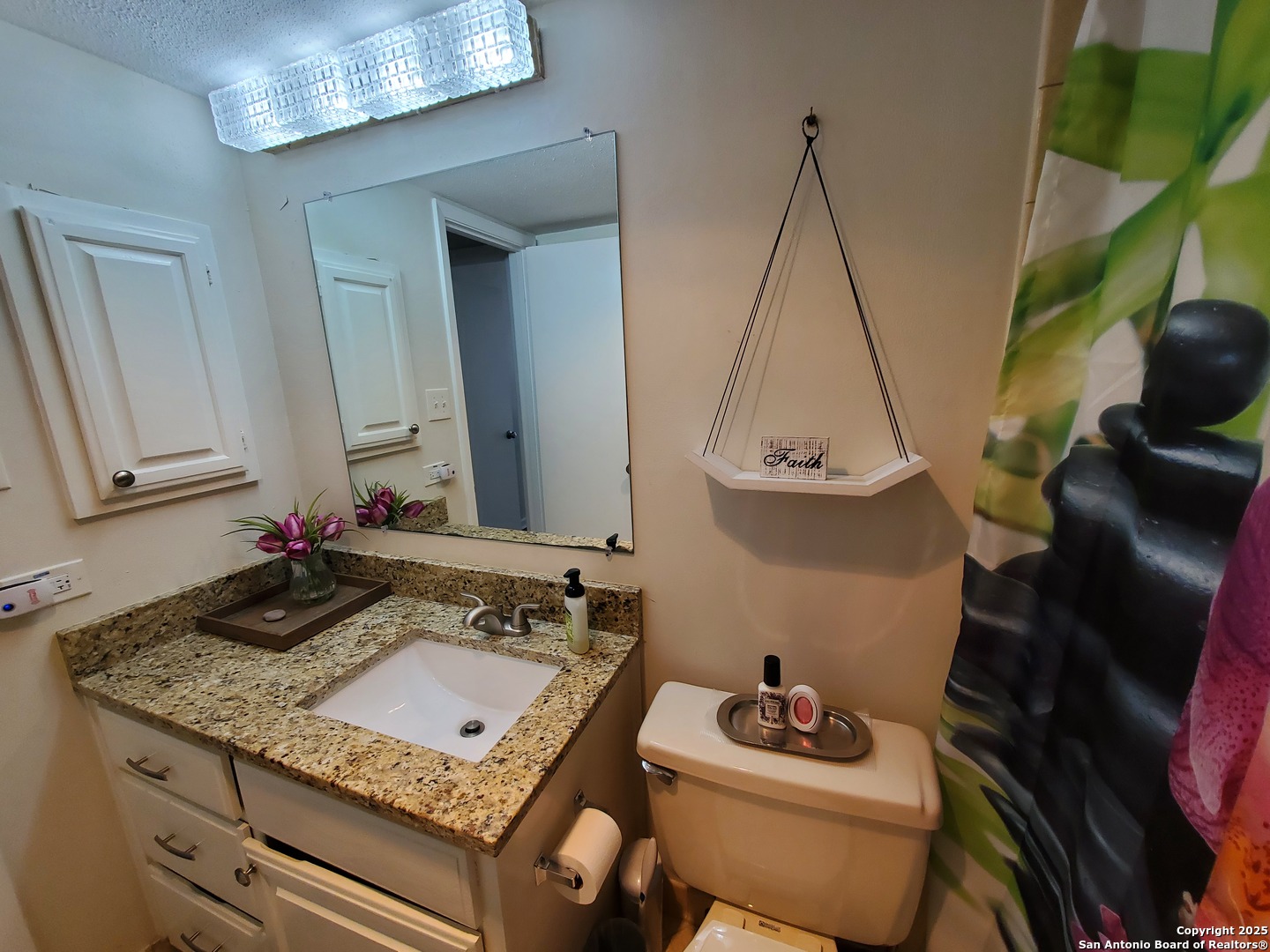 7701 Wurzbach Road, Unit 301 San Antonio, TX 78229 - Photo 40 of 42 a bathroom with a granite countertop sink a mirror and vanity