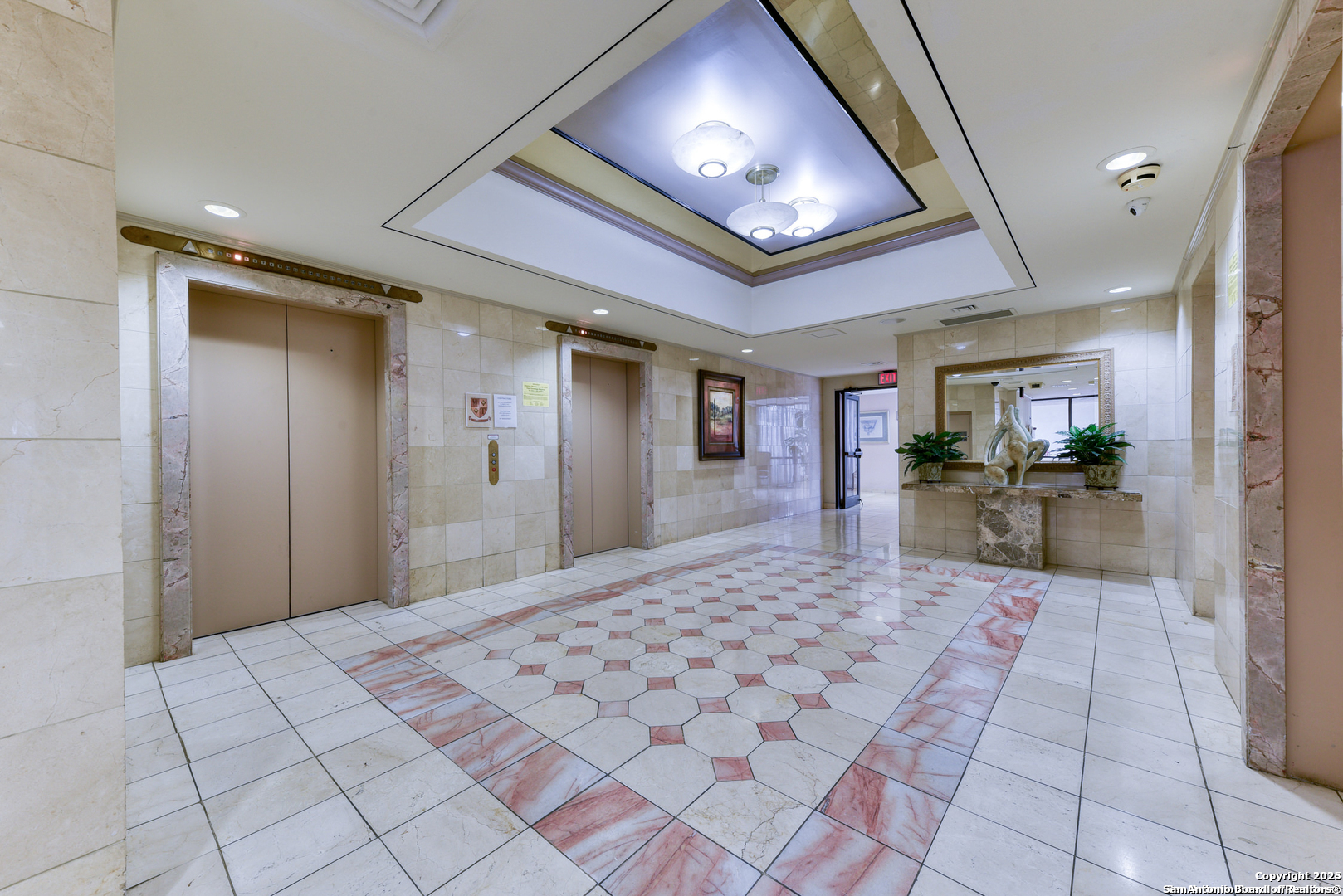 7701 Wurzbach Road, Unit 301 San Antonio, TX 78229 - Photo 9 of 42 a room with a chandelier and couch