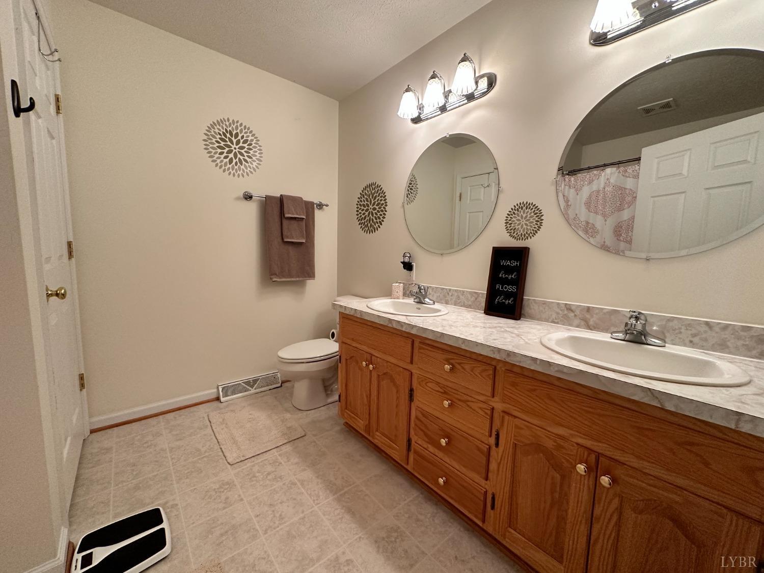 137 Rhonda Road Rustburg, VA 24588 - Photo 17 of 50 a spacious bathroom with a double vanity sink and a mirror