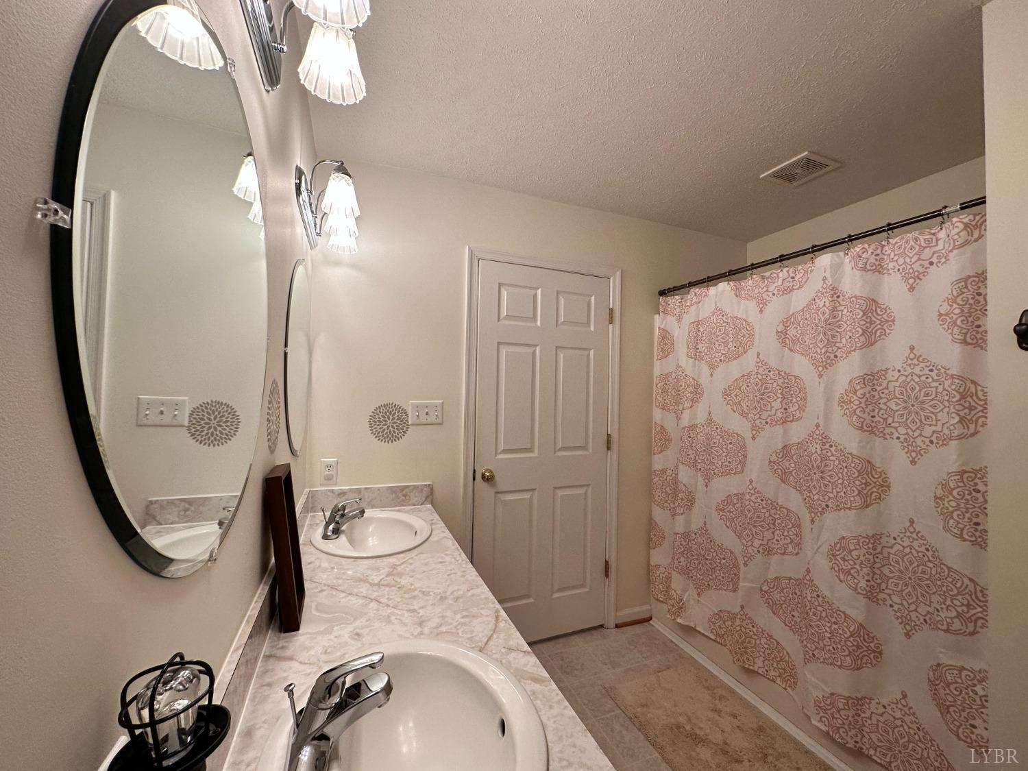 137 Rhonda Road Rustburg, VA 24588 - Photo 18 of 50 a bathroom with a granite countertop sink a mirror and shower