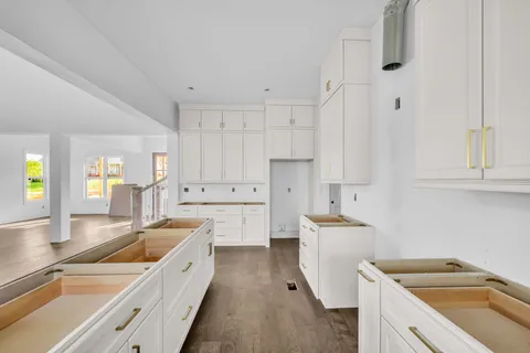 a kitchen that has a sink a stove and a oven
