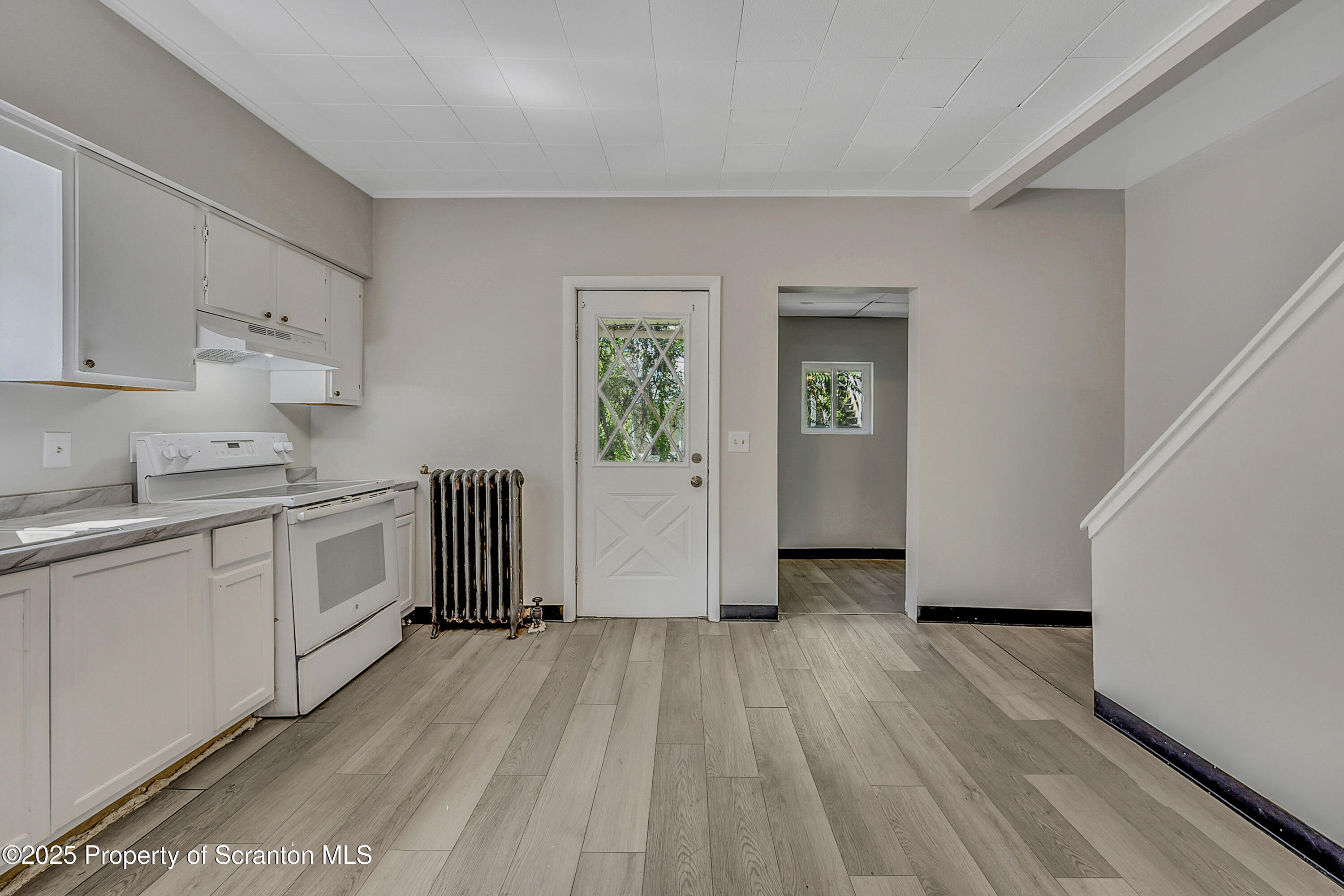 514 Stipp Court Scranton, PA 18510 - Photo 8 of 23 a kitchen with wooden floors and white appliances