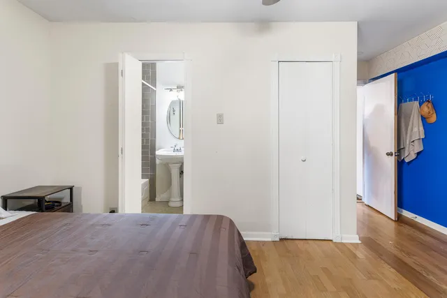 a view of a room with wooden floor and bathroom
