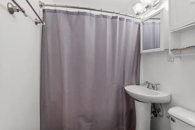 a bathroom with a sink a mirror and a toilet