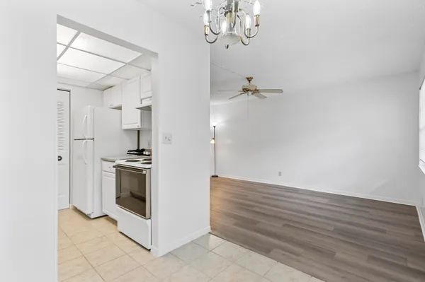 a view of a kitchen with a stove and a chandelier