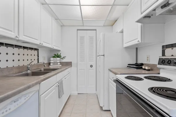 a kitchen with stainless steel appliances granite countertop a sink stove and cabinets