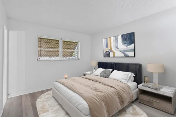 a bedroom with a bed and a night stand