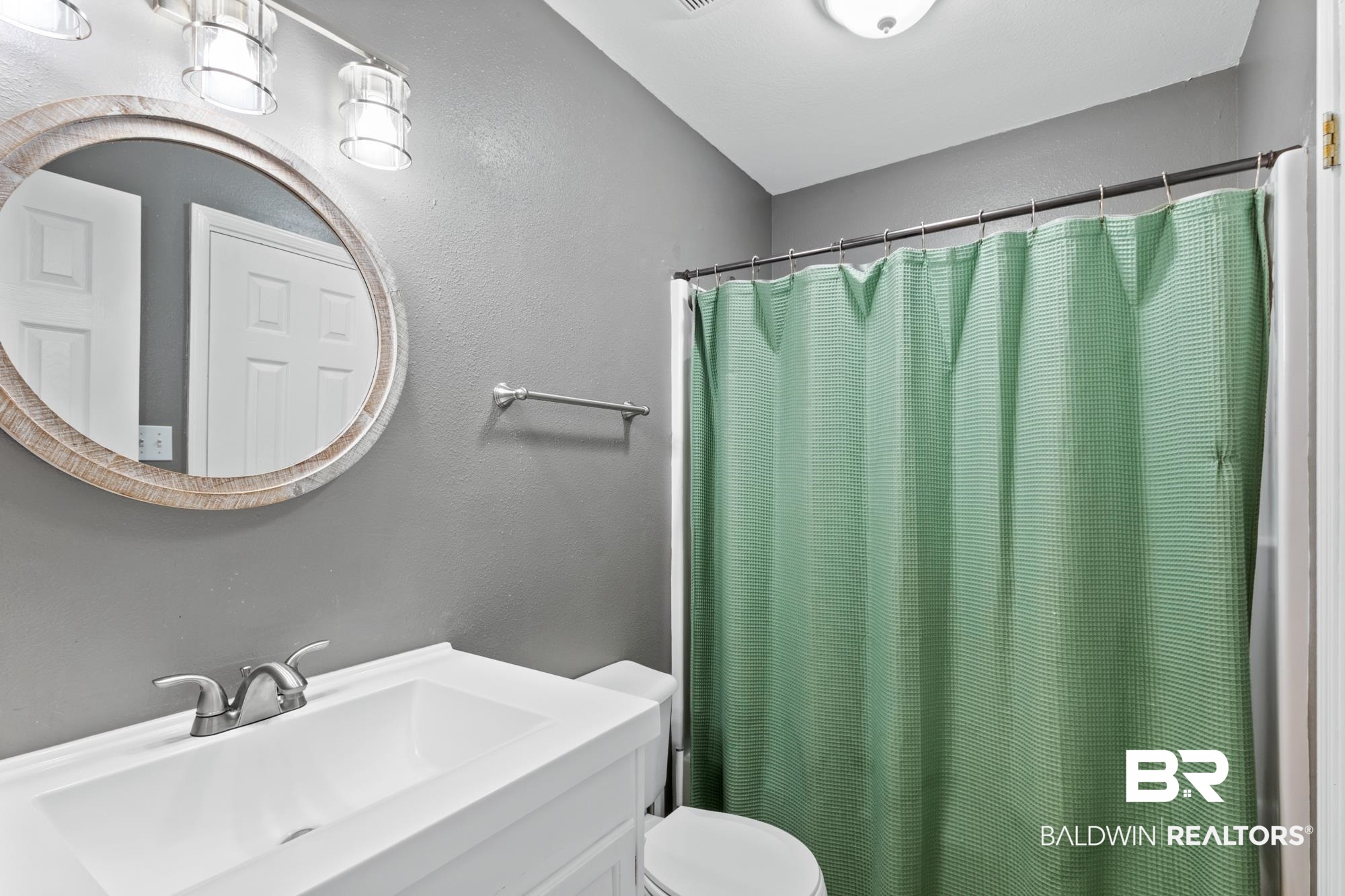 25925 -C Canal Road, Unit 203 Orange Beach, AL 36561 - Photo 16 of 57 Bathroom with vanity, toilet, and a shower with shower curtain