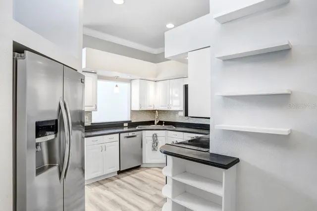 an empty room with a window and a ceiling fan