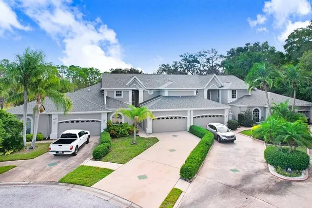 a front view of a house with a yard and potted plants