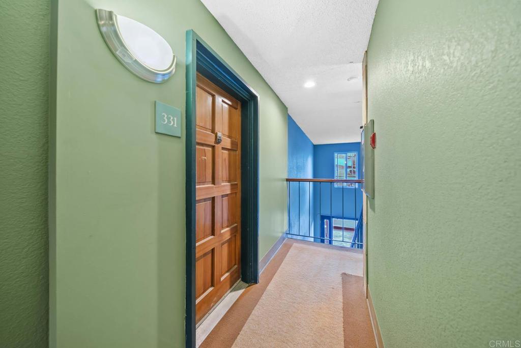 2360 Hosp Way, Unit 331 Carlsbad, CA 92008 - Photo 22 of 40 a view of a hallway with wooden floor and bathroom
