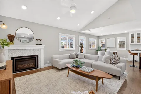 a living room with furniture a fireplace and a table