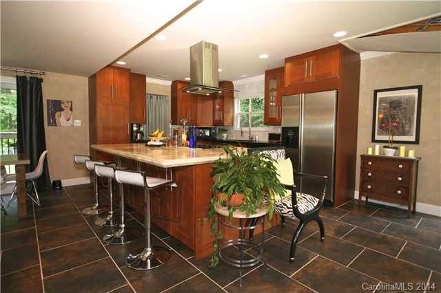 6795 Alanbrook Road Charlotte, NC 28215 - Photo 5 of 11 a kitchen with stainless steel appliances a sink a table and chairs in it