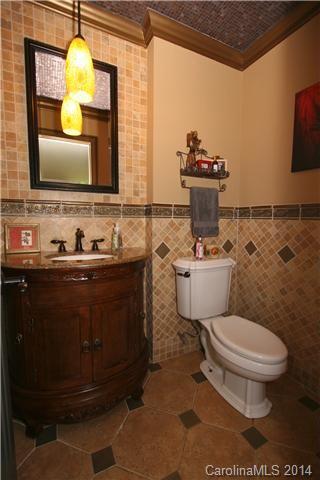 6795 Alanbrook Road Charlotte, NC 28215 - Photo 7 of 11 a bathroom with a sink and a mirror with toilet