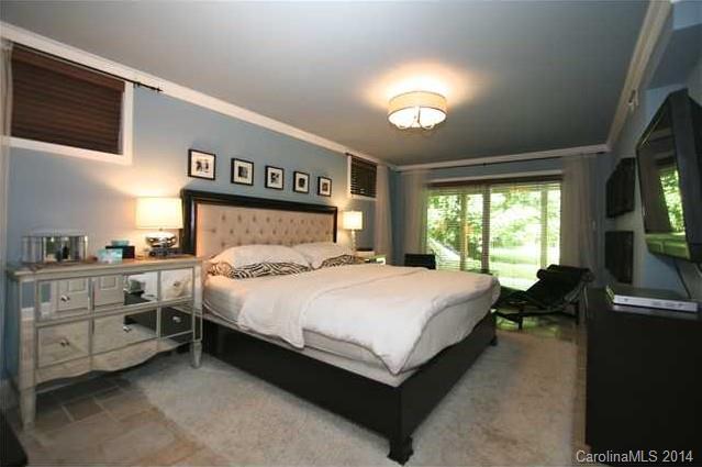 6795 Alanbrook Road Charlotte, NC 28215 - Photo 9 of 11 a bed sitting in a bedroom next to a window