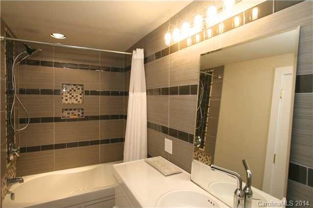 6795 Alanbrook Road Charlotte, NC 28215 - Photo 10 of 11 a bathroom with a bathtub and shower