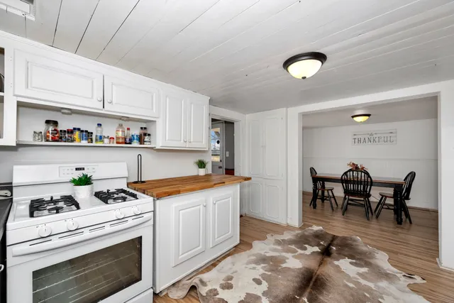 a kitchen that has a lot of cabinets in it and appliances