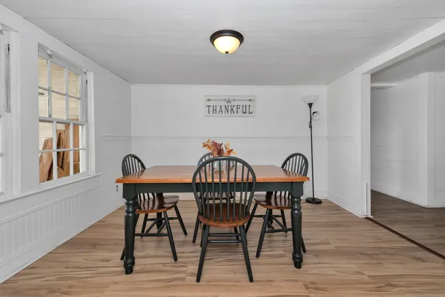 a view of a table and chairs in wooden floor