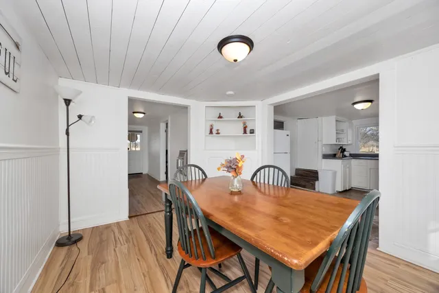 a dining room with furniture and wooden floor