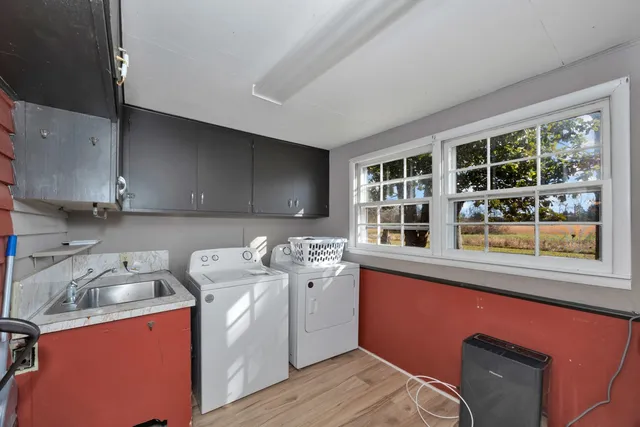 a utility room with sink dryer and washer