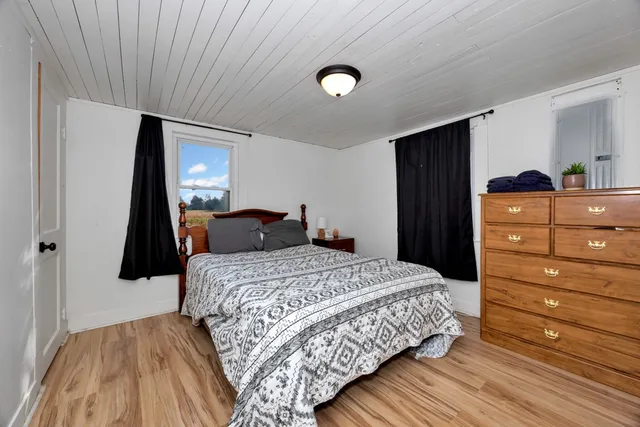 a bedroom with a bed and a dresser