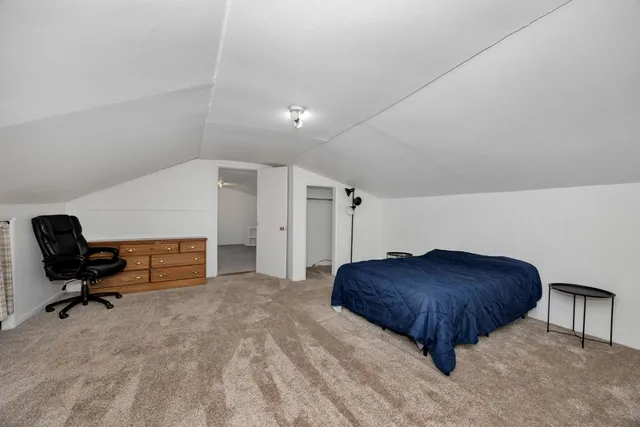 a bedroom with a bed and a chair