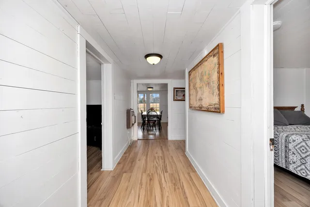 a view of a hallway view with wooden floor and furniture